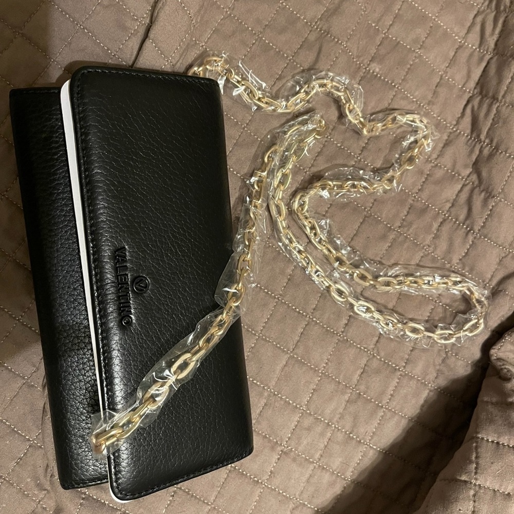 Valentino leather wallet with gold chain hardware.